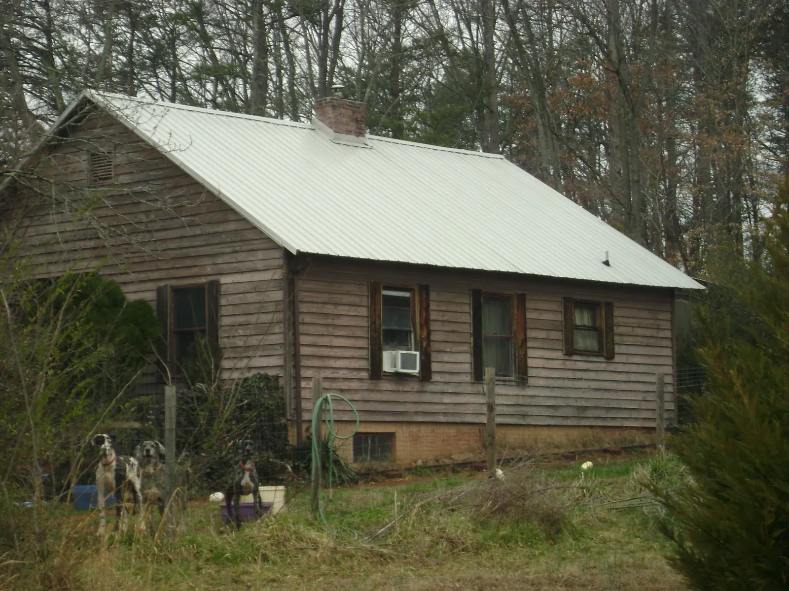 White metal roof on an old wood sided farmhouse, from a Metal Roof Installation job in Queensbury